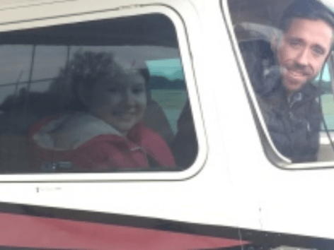 Picture of a youth and a pilot in an airplane