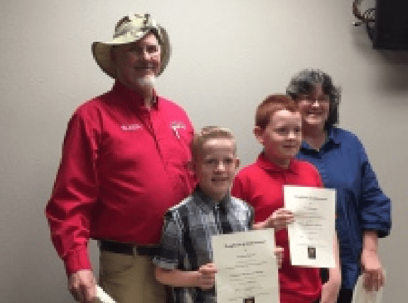 Picture of four writing contest winners holding their certificates
