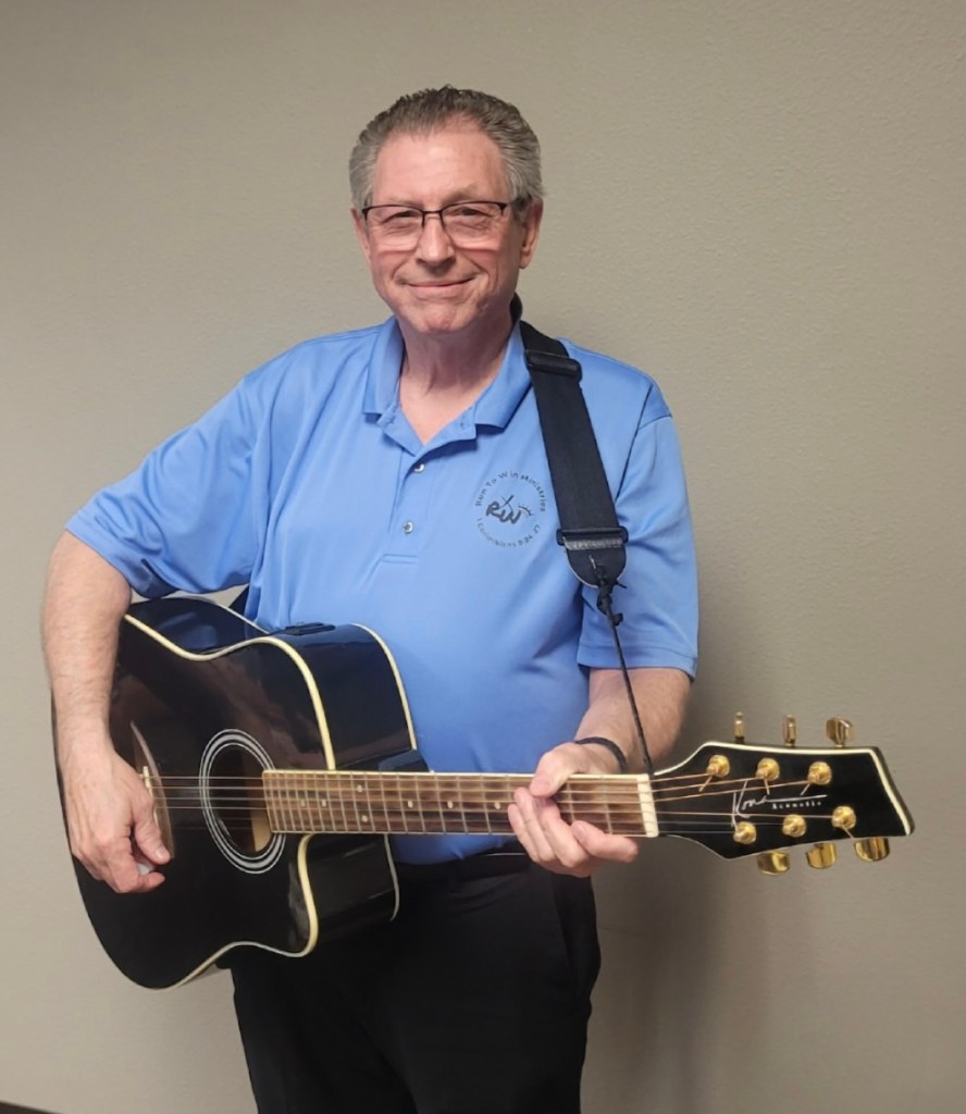 Picture of songwriter Jerry McCoy with his acoustic guitar