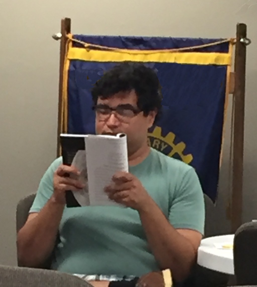 Picture of author Shane Tovar reading from his book, In the Night Sky