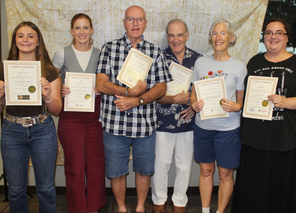 picture of six writers holding awards certificates